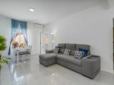a living room with a couch and a table at Algarsol 1bdr apartment near the beach in Quarteira