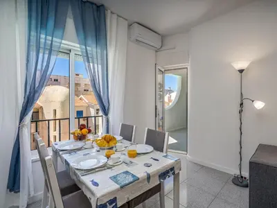 a dining room with a table and a balcony at Algarsol 1bdr apartment near the beach in Quarteira