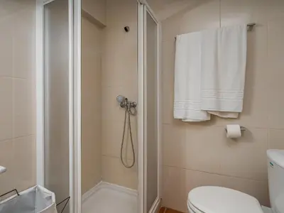 a bathroom with a shower and a toilet at T1 com Varanda e vista mar a 200m da Praia in Quarteira
