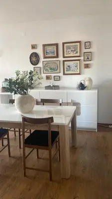 a white dining room with a table and chairs at Oura beach & sun in Albufeira