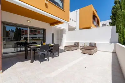 an outdoor patio with a table and chairs at Vitismar GroundFloor Apartment with Direct Pool Access in Albufeira in Guia