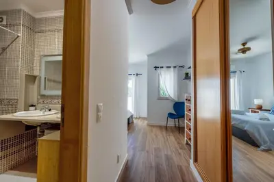 a bathroom with a sink and a bed in a room at Sunset Villa No 19 in Galé