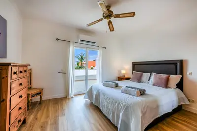 a bedroom with a bed and a ceiling fan at Sunset Villa No 19 in Galé