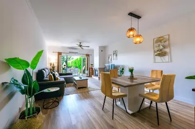 a living room and dining room with a table and chairs at Sunset Villa No 19 in Galé