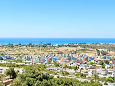 a city with colorful buildings in front of the ocean at Albufeira Amazing View With Pool by Homing in Albufeira