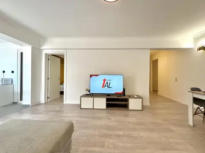 a living room with a television on a table at Albufeira Amazing View With Pool by Homing in Albufeira