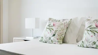 a white bed with three pillows on it at Elegant 2BDR Apartment in Quarteira by Lovelystay in Quarteira