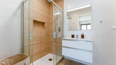 a bathroom with a glass shower and a sink at Elegant 2BDR Apartment in Quarteira by Lovelystay in Quarteira