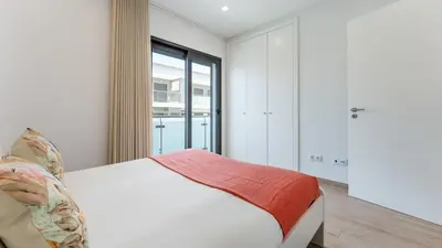 a bedroom with a bed and a large window at Elegant 2BDR Apartment in Quarteira by Lovelystay in Quarteira