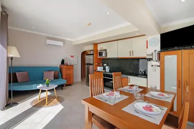 a kitchen and living room with a table and chairs at Casa Vista Mar in Albufeira