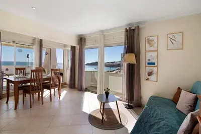 a living room with a couch and a table and chairs at Casa Vista Mar in Albufeira