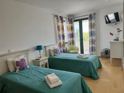 two beds in a room with green sheets at Marina Vilamoura - Aquamar 205 - 3 Quartos in Quarteira
