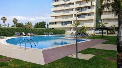 a swimming pool in front of a building at Marina Vilamoura - Aquamar 205 - 3 Quartos in Quarteira