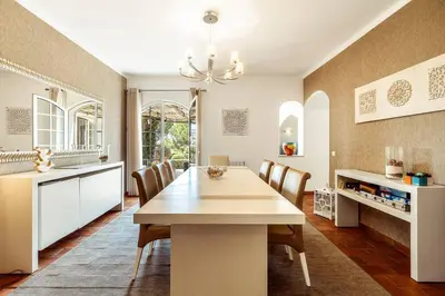 a kitchen and dining room with a table and chairs at Lovely Very Private Villa with Beautiful Gardens in Guia