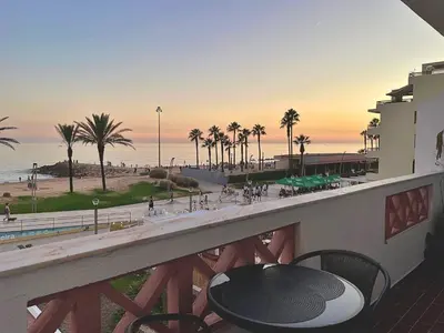 a balcony with a table and a view of the beach at Sunflower12 - Apartamento à beira-mar - Seaview in Quarteira
