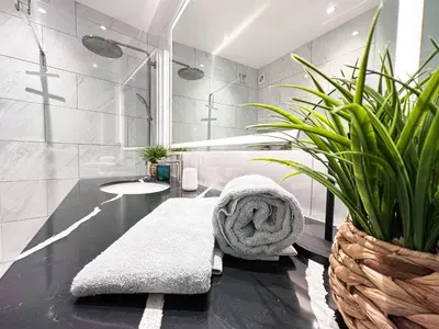 a bathroom with a bench and plants in it at Luxury Beach House - Casa do Farol by BeCherish in Albufeira