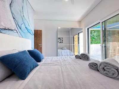 a bedroom with a large bed with towels on it at Luxury Beach House - Casa do Farol by BeCherish in Albufeira