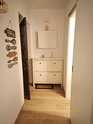 a hallway with a white dresser in a room at Charmoso T1 Varandas de Malpique in Albufeira