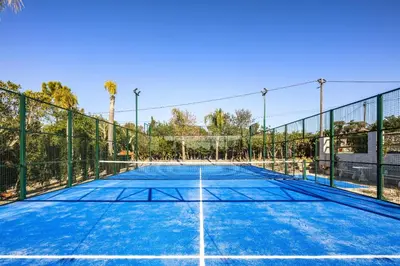 a tennis court with a net on a tennis court at Villa Avalon - Bedzy Luxury in Almancil