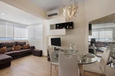 a living room with a couch and a flat screen tv at Faro Downtown Suites - Ria Formosa in Faro