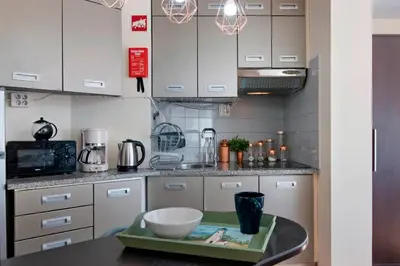 a kitchen and dining room with a table and chairs at Faro Downtown Suites - Ria Formosa in Faro