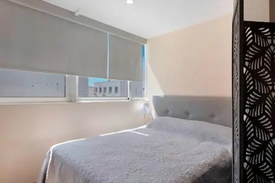 a bedroom with a bed and some windows at Faro Downtown Suites - Ria Formosa in Faro