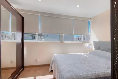 a bedroom with a bed and a table in a room at Faro Downtown Suites - Ria Formosa in Faro