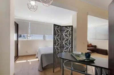 a living room with a table and a couch at Faro Downtown Suites - Ria Formosa in Faro