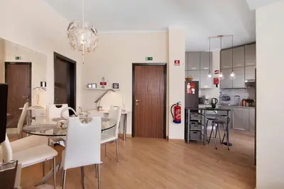 a kitchen and dining room with a table and chairs at Faro Downtown Suites - Ria Formosa in Faro