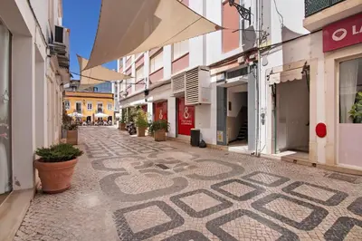 an empty street with a mosaic on the ground at Faro Downtown Suites - Ria Formosa in Faro