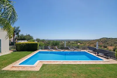 a swimming pool in the yard of a house at Excelente Studio in Loulé