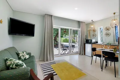 a living room with a couch and a table at Excelente Studio in Loulé