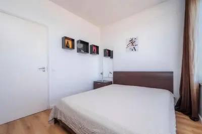 a bedroom with a bed and some pictures on the wall at Encanto da Ria in Faro