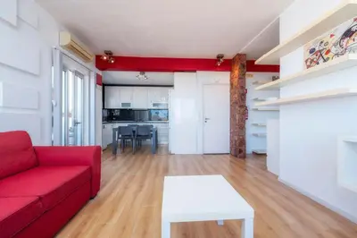 a living room with a red couch and a white table at Encanto da Ria in Faro
