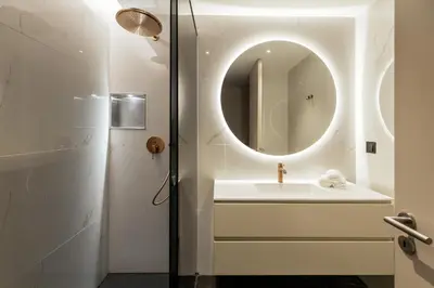 a bathroom with a sink and a mirror at The View at The Downtown Faro in Faro