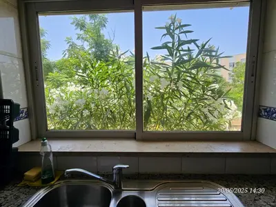 a kitchen sink with a window above a kitchen counter at Blife Candya private apartment in Monte Negro