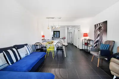 a living room with a blue couch and a table at Kyara House in Albufeira