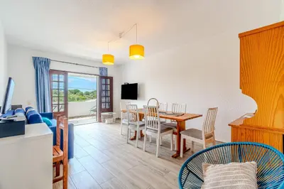 a living and dining room with a table and chairs at A Casa da Ana - By Algarkasa in Albufeira