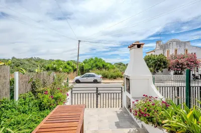 a house with a gate and a car on a street at A Casa da Ana - By Algarkasa in Albufeira