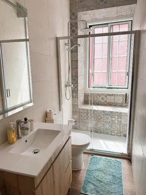 a bathroom with a sink and a toilet and a shower at Sao Pedro Guest House in Faro