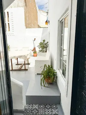 an open door to a balcony with potted plants at Sao Pedro Guest House in Faro