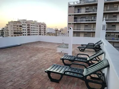 a group of benches sitting on the roof of a building at Guest House Mercado in Faro