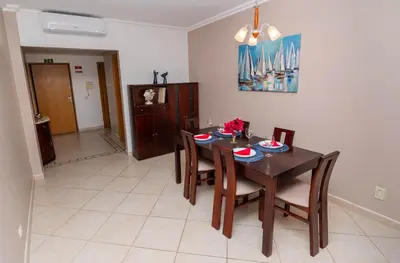 a dining room with a wooden table and chairs at Ver o Mar in Albufeira