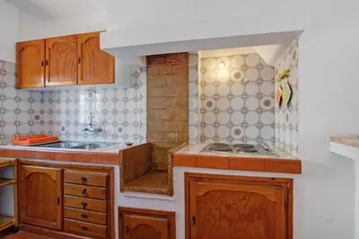 a kitchen with a washing machine and a microwave at Casa Mar Sol E Sossego in Albufeira