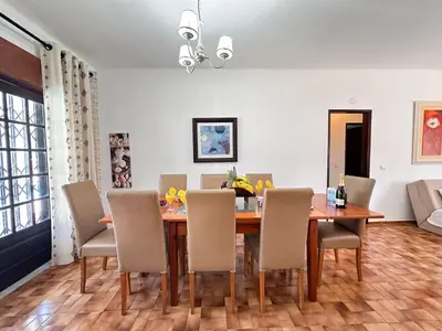 a dining room with a table and chairs at Vista Golf by Becherish in Bicas