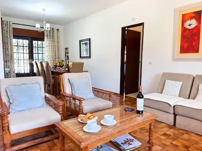 a living room with a couch and a table with a bottle of wine at Vista Golf by Becherish in Bicas