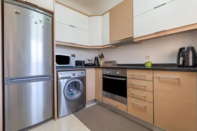 a kitchen with a stainless steel refrigerator and a dishwasher at Vale Parra Vilage T2 in Guia