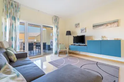 a living room with a couch and a flat screen tv at Vale Parra Vilage T2 in Guia