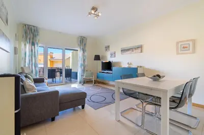 a living room with a table and a couch at Vale Parra Vilage T2 in Guia