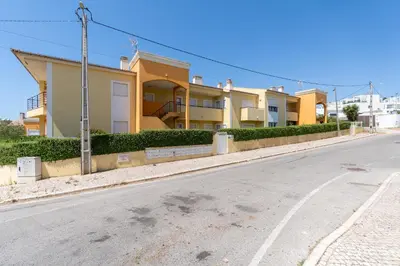 a patio with chairs and a table on a balcony at Vale Parra Vilage T2 in Guia